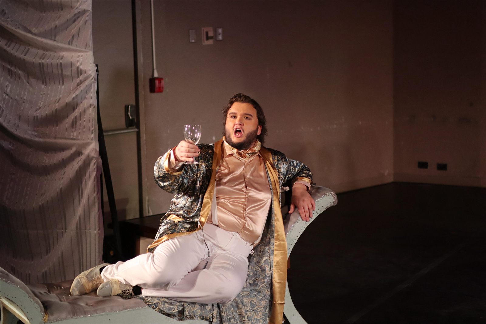 Rhys Stermer seated in an opera production.