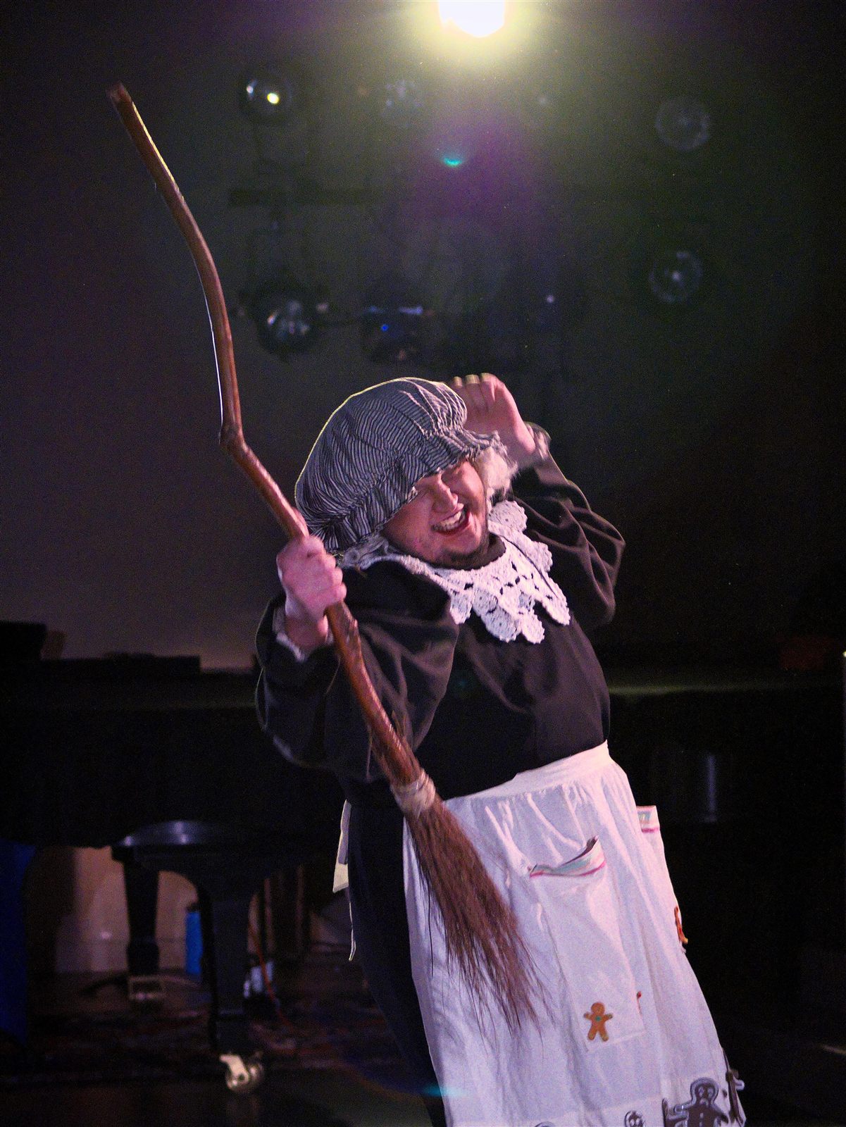Rhys Stermer in a theatrical pose under stage lighting.